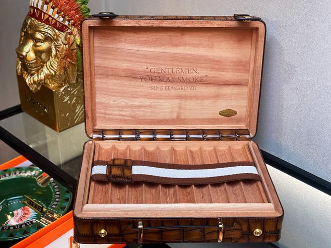 一支点燃的顶级古巴雪茄与雪茄盒，露出其精致的纹理和细节